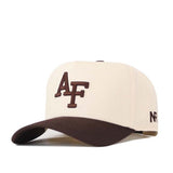 The Air Force Espresso Hat by No Rivals is a beige baseball cap with a brown brim and prominent brown embroidered “AF” lettering on the front. Made from high-quality cotton, this officially licensed snapback also features smaller brown “NR” text on the side.