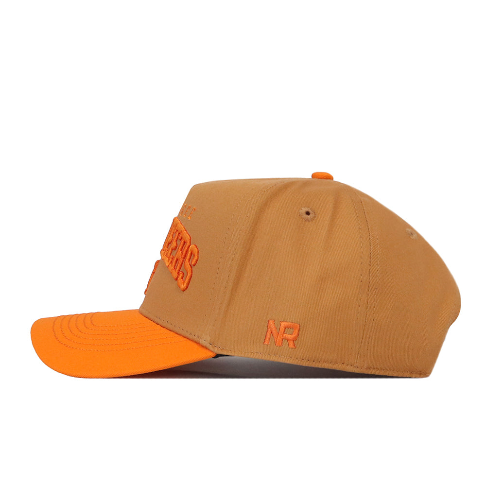 Introducing the Tennessee Rivalry Hat by No Rivals: A tan baseball cap accented with an orange brim and bold orange embroidery, showcased in a side view. The initials “NR” are stitched near the back, while the high-quality cotton construction and snapback closure ensure comfort and style. An eye-catching embroidered logo provides a distinctive finishing touch.