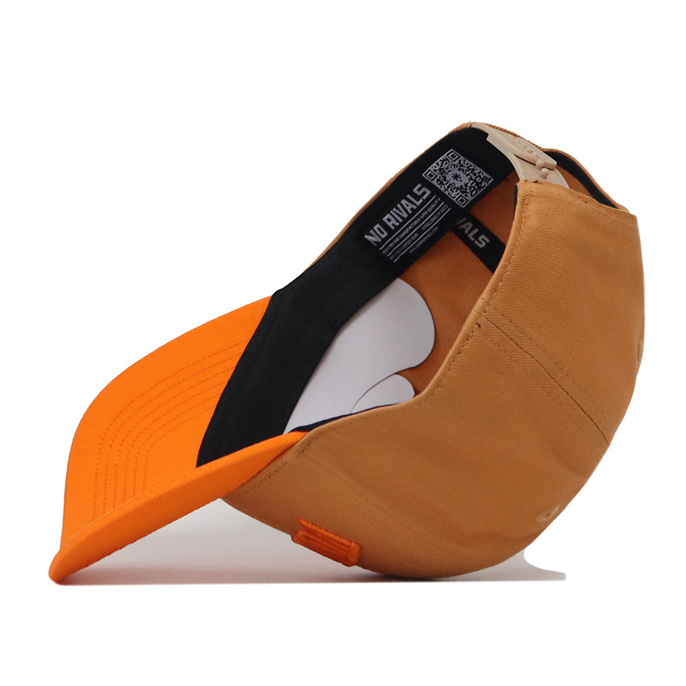 The Tennessee Rivalry Hat by No Rivals features a tan crown and an orange bill, displayed on its side to reveal the inner label with the brand’s name. Made from high-quality cotton, this structured cap showcases visible stitching, a black inner band, and a snap back closure for an adjustable fit.