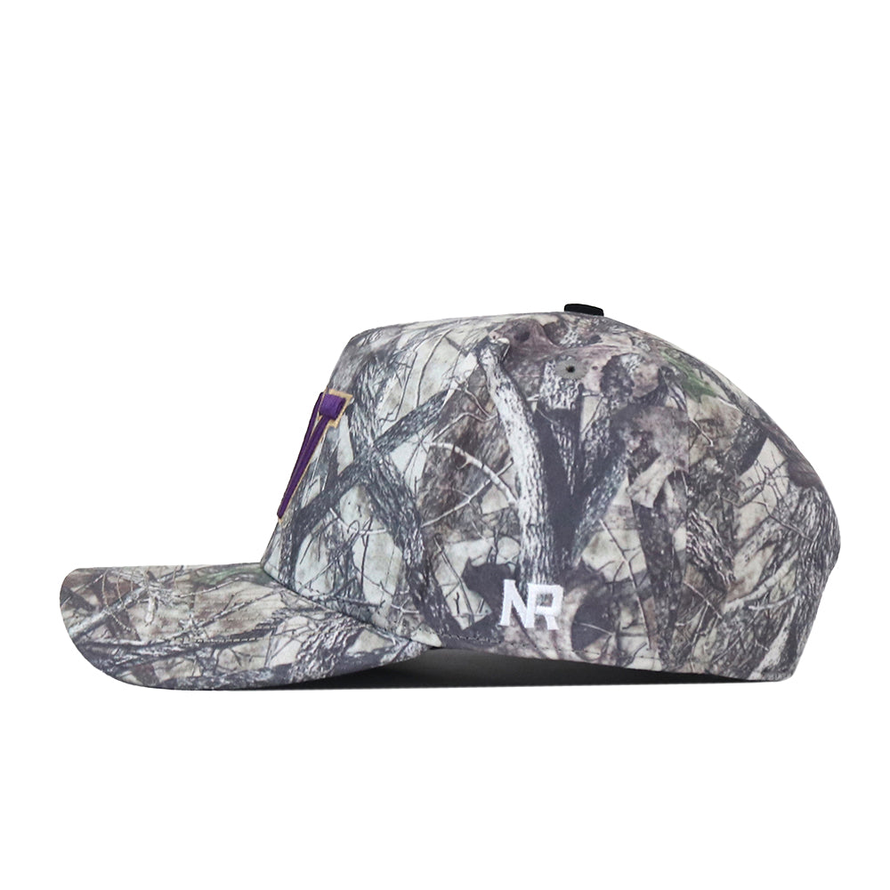 Side view of the officially licensed Washington Huskies Outland Hat by No Rivals, featuring a camouflage pattern. The side displays white “NR” embroidery, while a small purple accent decorates the front. Includes a convenient snapback closure for an adjustable, comfortable fit.
