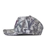 Side view of the officially licensed Washington Huskies Outland Hat by No Rivals, featuring a camouflage pattern. The side displays white “NR” embroidery, while a small purple accent decorates the front. Includes a convenient snapback closure for an adjustable, comfortable fit.
