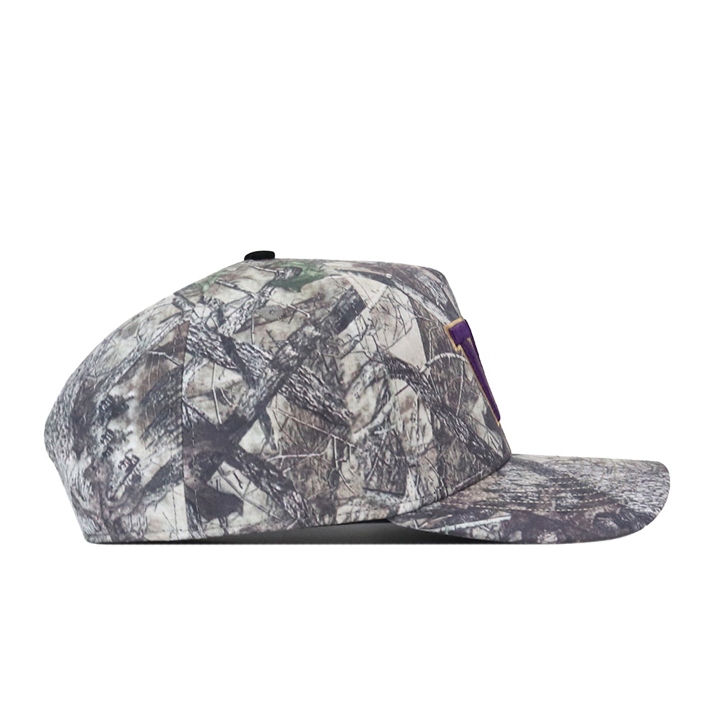 A side view of the Washington Huskies Outland Hat by No Rivals, showcasing its flat-brim design and a camouflage pattern in shades of gray, brown, and green. The hat features an embroidered logo on the front for added style, while the snap back adjustment provides a comfortable, customizable fit.