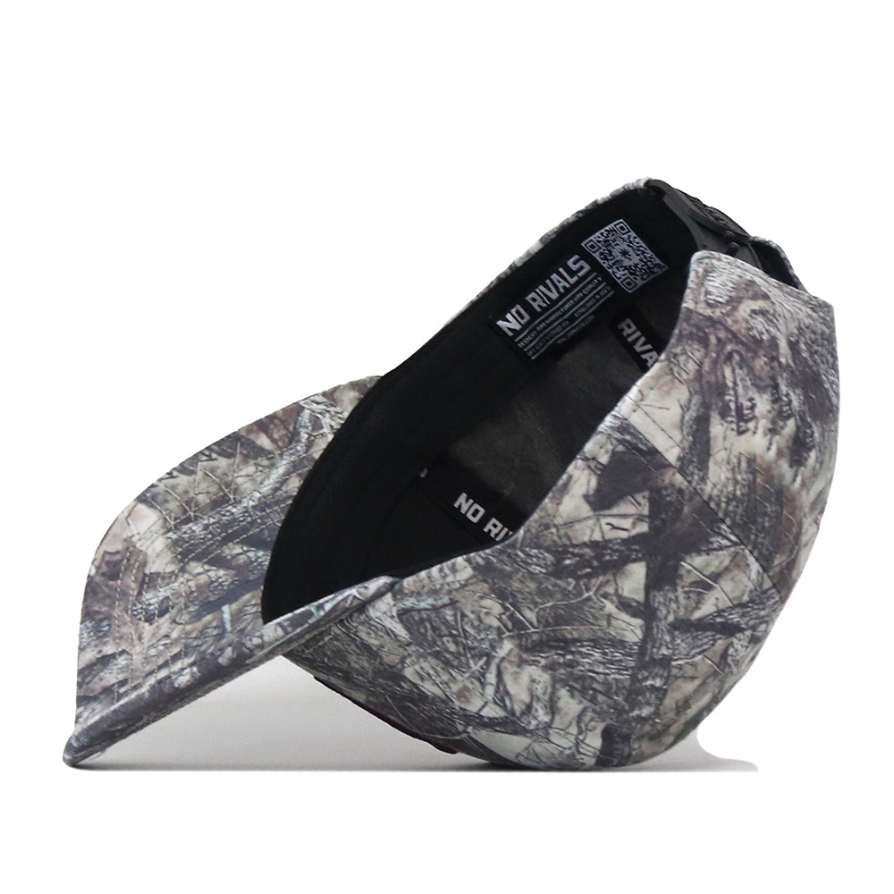 The Washington Huskies Outland Hat by No Rivals is displayed upside down, revealing the interior tags and labels. The inside of the officially licensed cap features the NO RIVALS text and an embroidered logo, while a convenient snap back adjustment ensures a customizable fit.