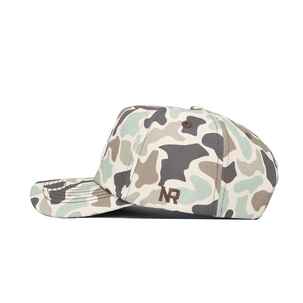 The Iowa Huntsman Hat by No Rivals is a 5-panel camo snapback in green, beige, and brown shades with "NR" embroidered in black on the side. Shown from a side angle against a white background.