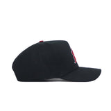 The No Rivals Iowa State Patch Hat - Black is a high-quality cotton snapback with a slightly curved brim, viewed from the side, and features a partially visible red emblem on the front.