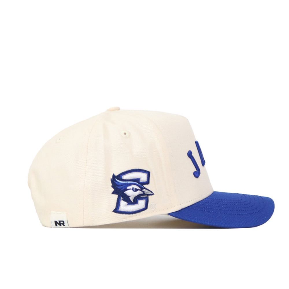 The No Rivals Right Side Up JAYS Hat - Creighton - Classic Colors is a cream cotton-canvas baseball cap with a blue brim, embroidered blue jay head and large "C", structured fit, snap back, and partial blue writing on the front.