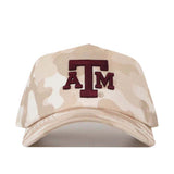 The Texas A&M Sand Camo Hat - Unstructured by No Rivals features a beige camouflage design with an embroidered maroon ATM logo on the front. This officially licensed snapback cap offers both comfort and style for any fan.