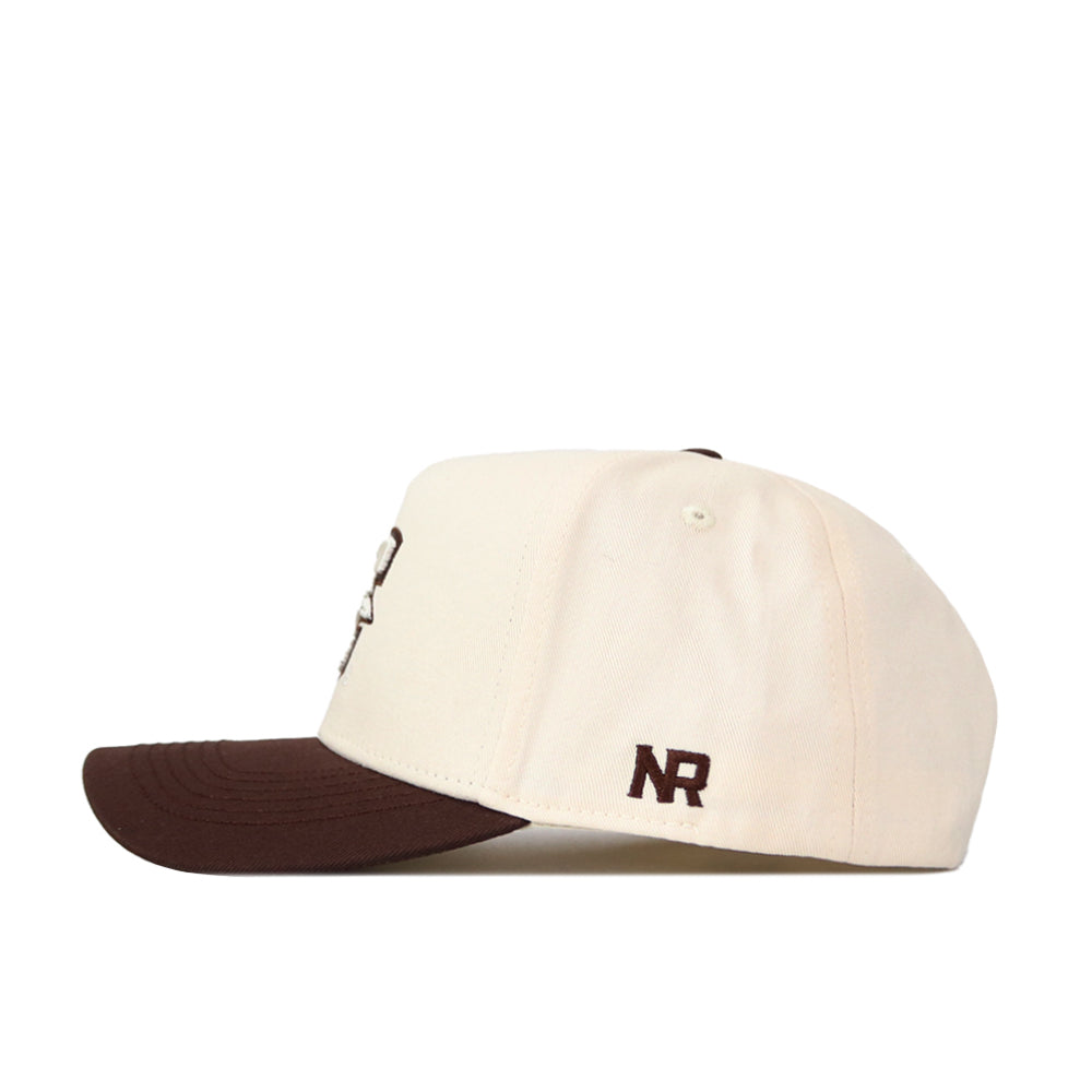 The No Rivals Creighton Espresso Hat features a cream snapback design with a dark brown brim. Made from high-quality cotton, "NR" is embroidered in dark brown thread on the side near the back.