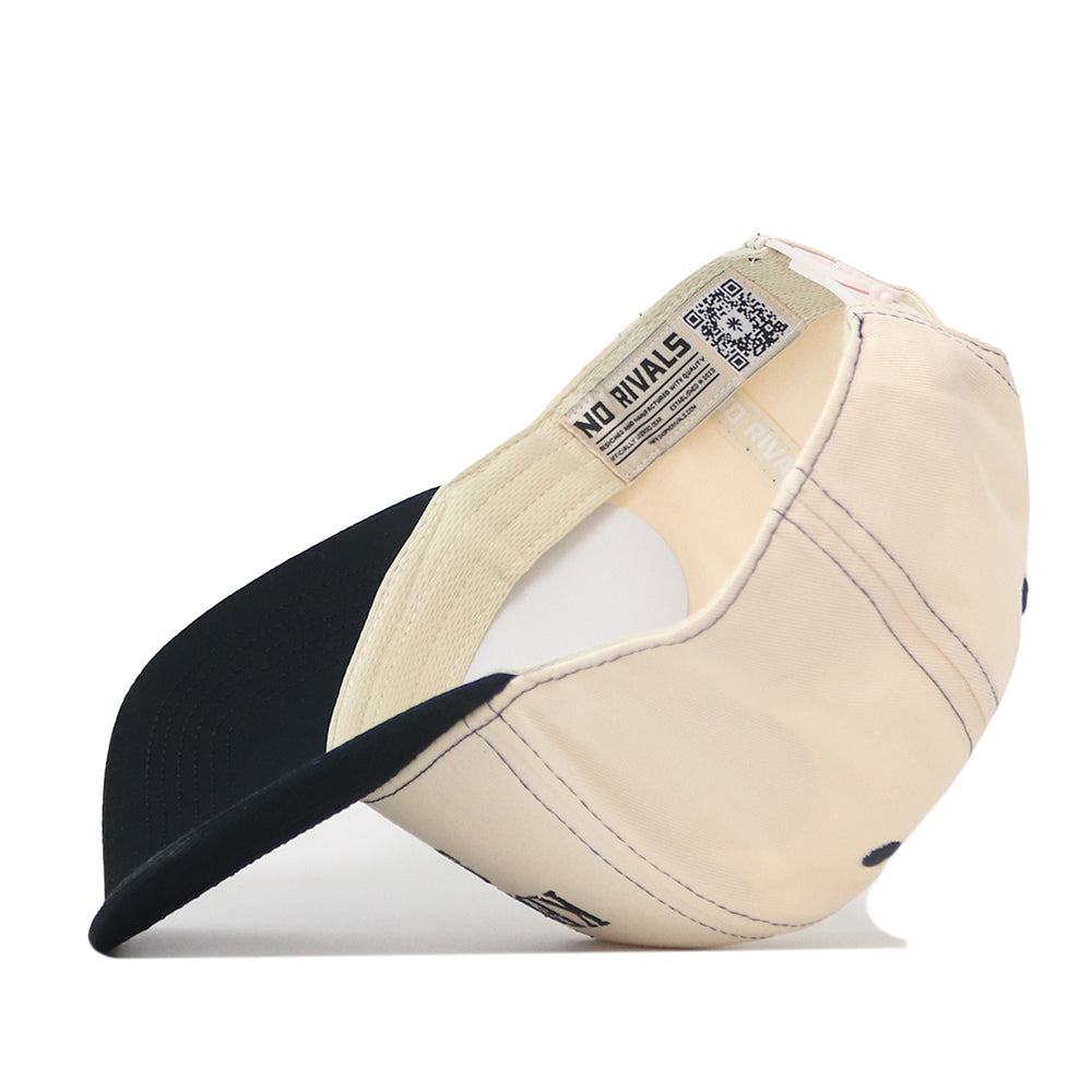 A Kennesaw State Owls Vintage Hat by No Rivals is shown turned inside out, displaying the interior label reading “No Rivals” and a QR code on the inner band. The beige and black baseball cap features a snap back adjustment for a customizable fit.