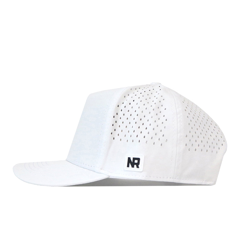 A side view of the Washington Huskies Golf Hat in white, by No Rivals. This cap features a perforated design with a flat brim, a small black and white NR embroidered logo patch on the lower side panel, and an adjustable snap back for your ideal gameday fit.