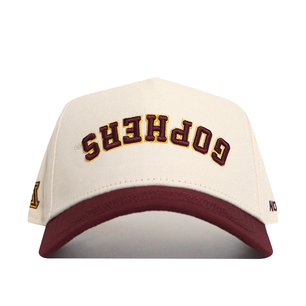 The No Rivals Minnesota Golden Gophers Upside Down Gophers Hat - Classic features a cream and maroon snapback design with “GOPHERS” embroidered upside down on the front in maroon and gold, making it an officially licensed standout for any fan.