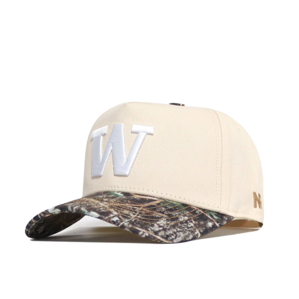 Introducing the Washington Camo Connector Hat by No Rivals—a beige snapback cap with a bold white embroidered "W" on the front and a striking camouflage-patterned brim, officially licensed for authentic style.