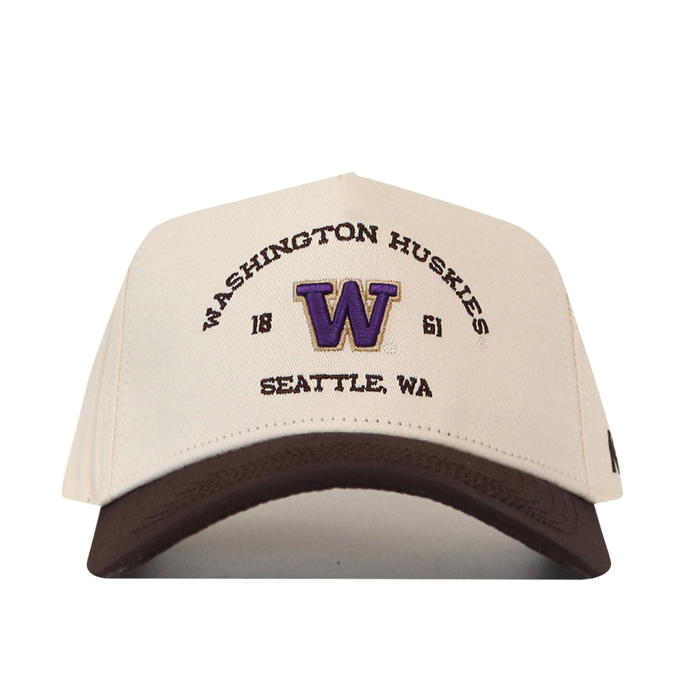 The No Rivals Washington Huskies Outlaw Hat – Classic is a white and brown snapback cap, officially licensed, with “Washington Huskies 1861 Seattle, WA” embroidered in purple and black and a large purple W logo at the center.