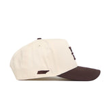 The No Rivals ETSU Espresso Hat is a beige snapback with a brown brim and a small brown state-shaped patch on the side, crafted from high quality cotton and shown from the left for a structured fit.
