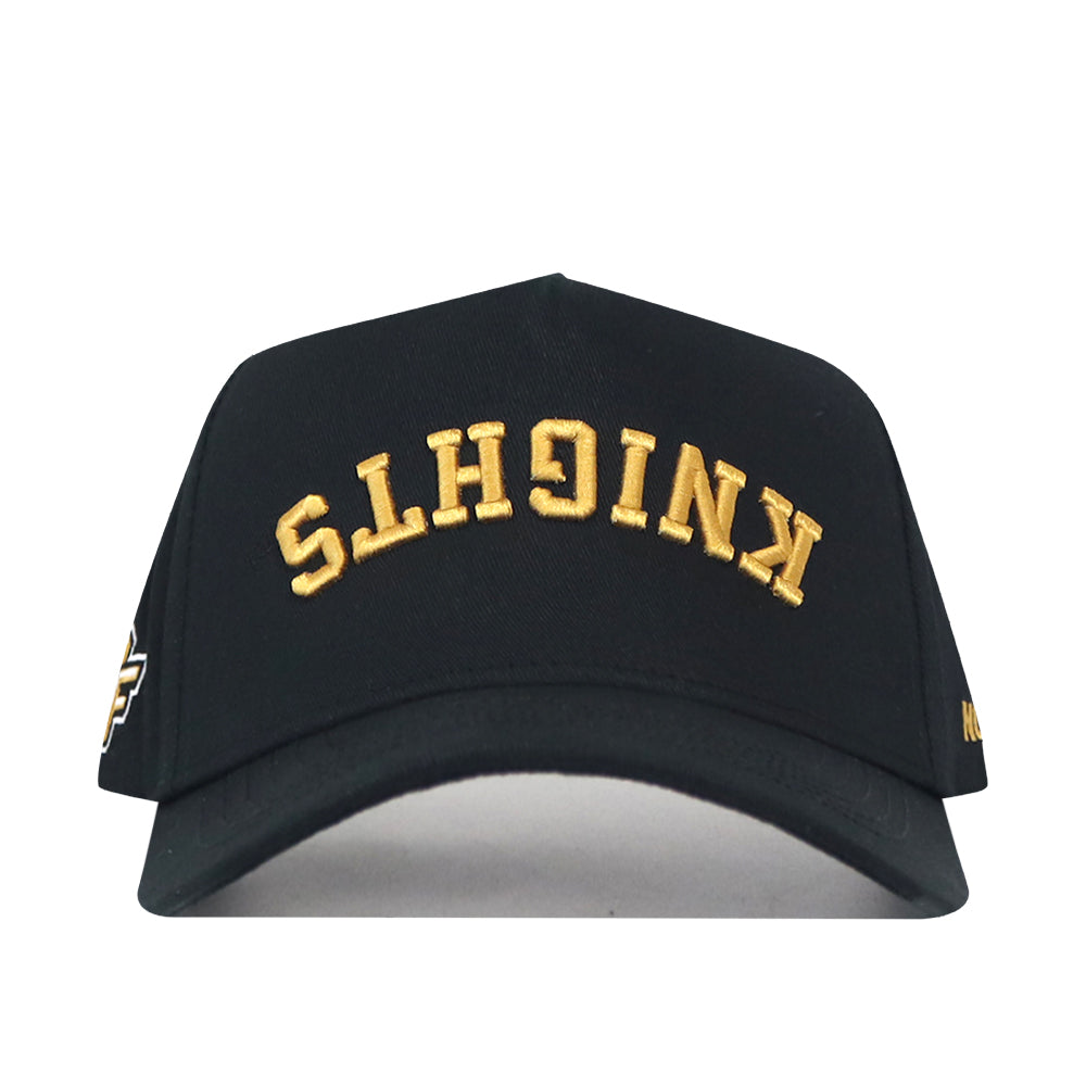 Show your team pride in style with the UCF Knights | Upside Down Knights Hat - Blackout by No Rivals. This officially licensed black snapback features “KNIGHTS” embroidered in gold upside down on the front.