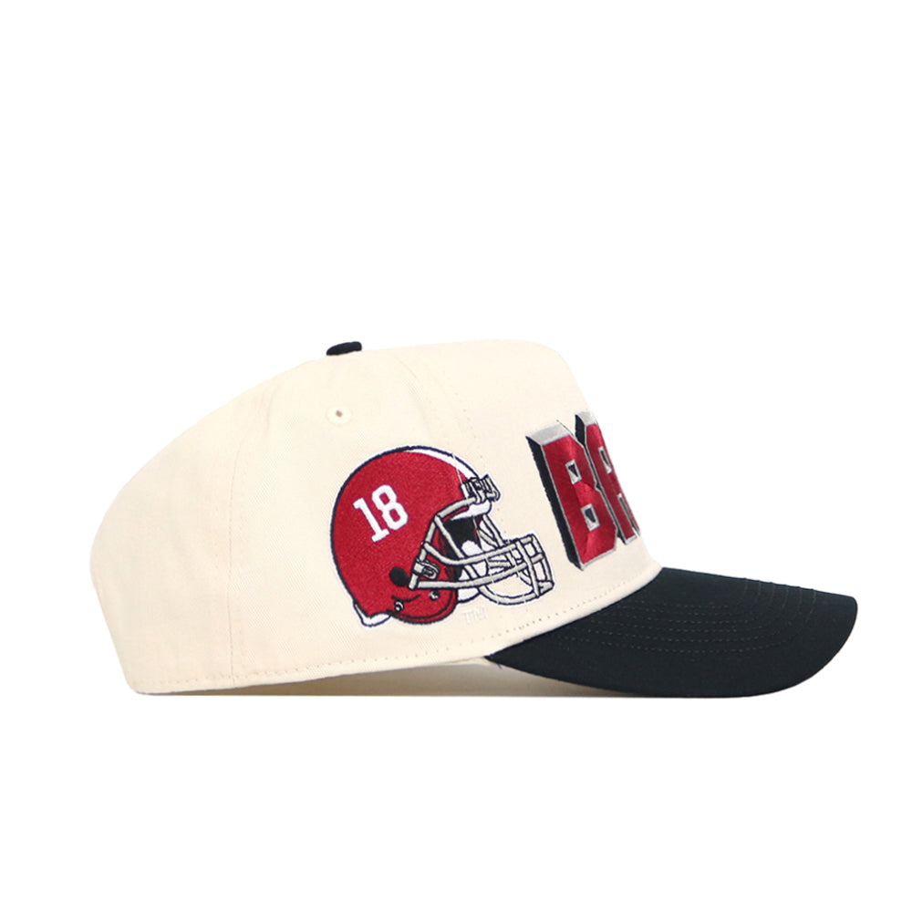 The No Rivals Alabama Alma Mater Hat is a cream snapback with a black brim, featuring a red football helmet with number 18 and bold red and black BAMA text embroidered on the side.