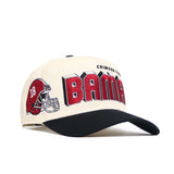 The No Rivals Alabama Alma Mater Hat is a cream snapback with a black brim, showcasing a red football helmet with “18” and bold red BAMA text, plus "CRIMSON TIDE" above. Officially licensed and structured for lasting style.