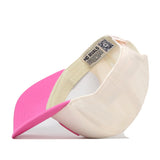 A Miami Pink Out Hat by No Rivals is shown upside down, revealing its interior label with the brand name. The bright pink brim and light beige body make this snap back baseball cap a standout choice for anyone seeking a stylish breast cancer hat.