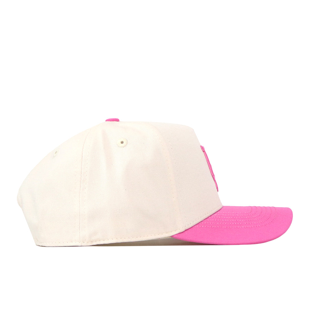 The Oregon Pink Out Hat by No Rivals is a white snap back baseball cap featuring a pink brim and pink button on top, shown in side profile against a plain white background. Officially licensed by the Breast Cancer Foundation, this stylish hat is both fashionable and supportive of an important cause.