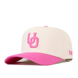 Show your support for the Breast Cancer Foundation with the Oregon Pink Out Hat by No Rivals. This officially licensed white snapback features a vibrant pink brim and bold pink embroidered “UD” letters on the front, accented with smaller pink text on the side for a stylish look.
