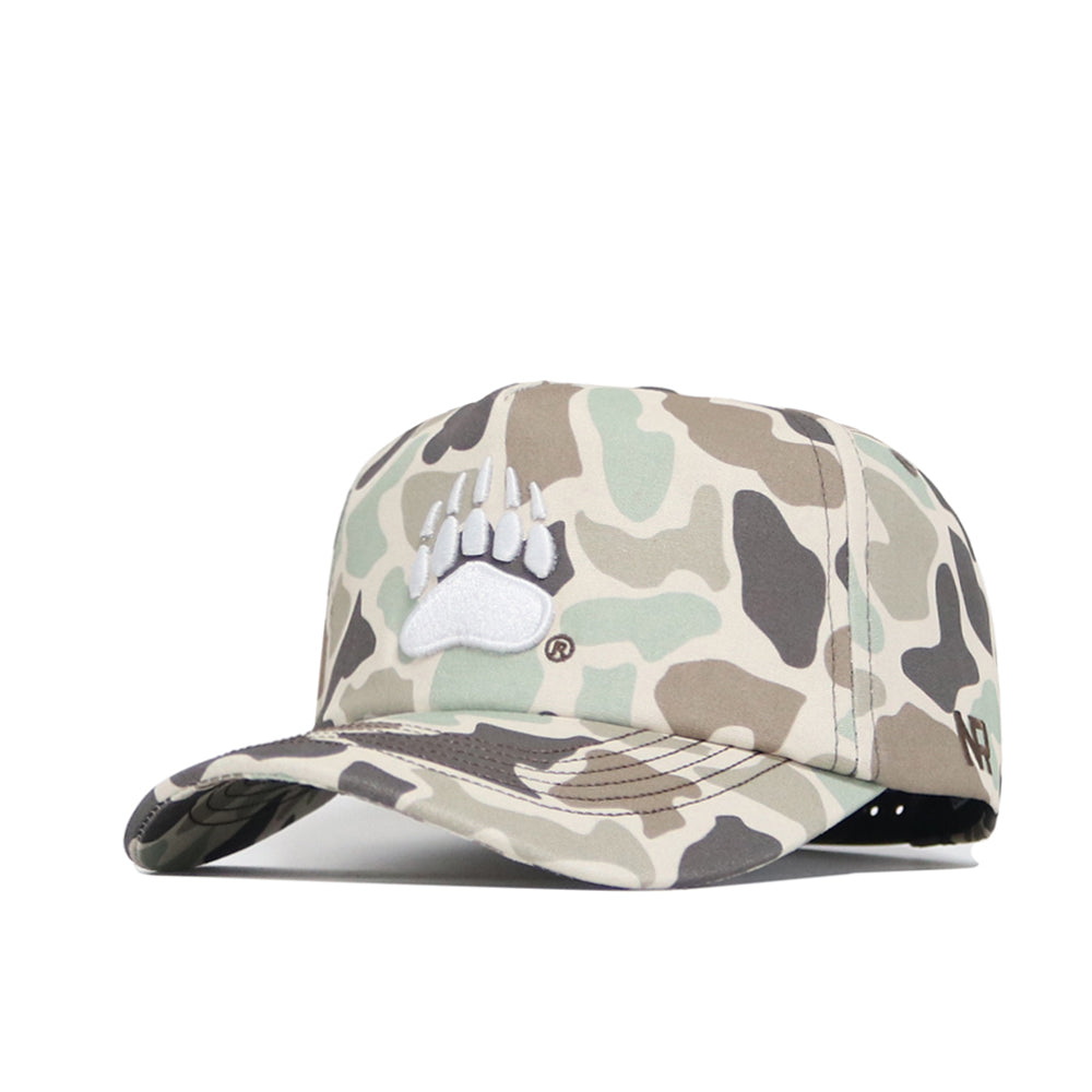 The Montana Huntsman Hat by No Rivals is a 5-panel duck camo cap with a white embroidered bear paw on the front and an adjustable snap back for a custom fit.