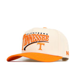The No Rivals Tennessee Stride Hat is a beige and orange snapback with "Volunteers Tennessee" and a large embroidered logo on the front, an orange bill, detailed side embroidery, and is crafted from high quality cotton.