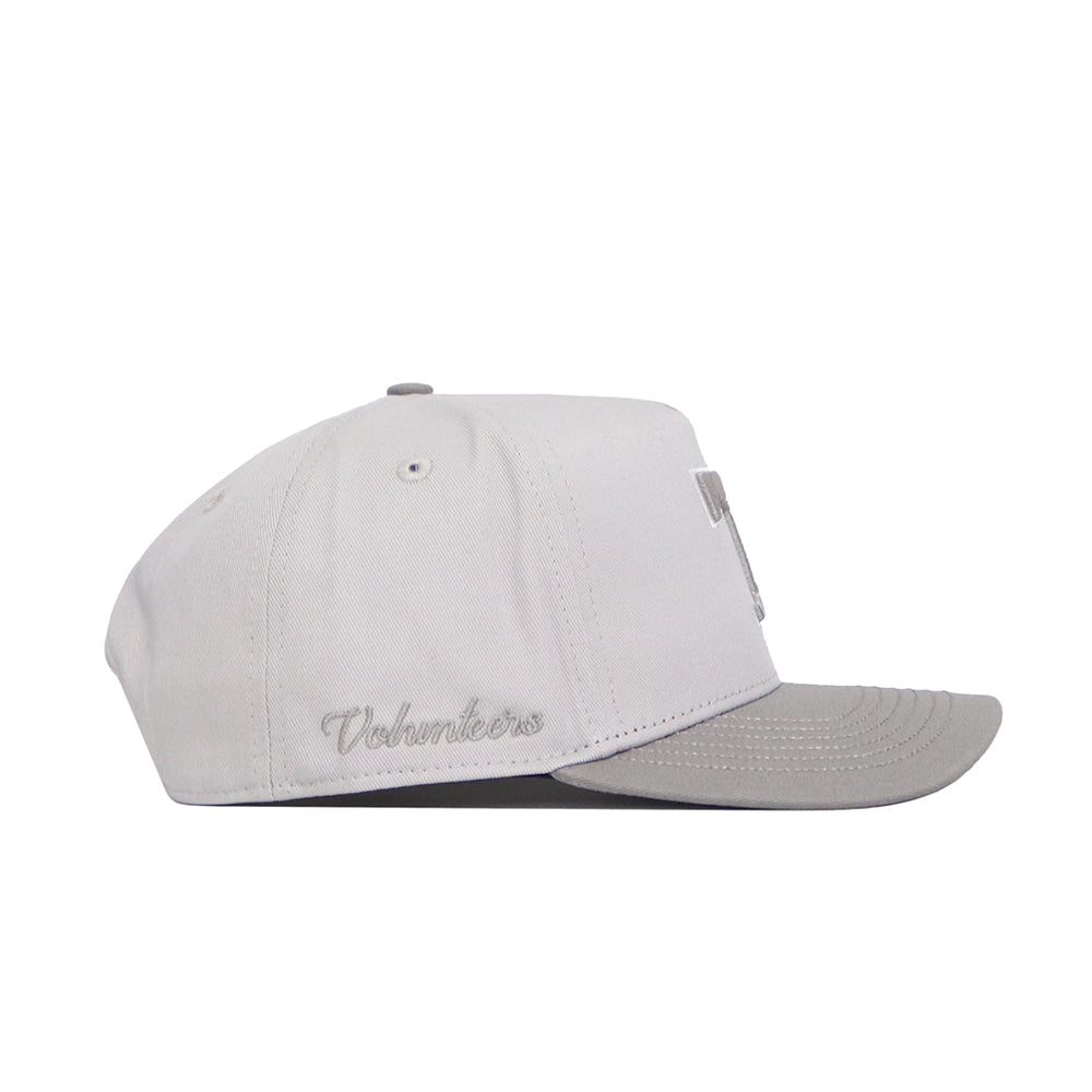 Side view of the Tennessee Graphite Hat by No Rivals in light gray with a darker flat brim. “Volunteers” is embroidered in cursive near the back, along with classic embroidered graphics.