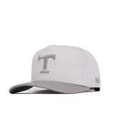 The No Rivals Tennessee Graphite Hat features a structured light gray design with a flat bill, raised silver "T" embroidery on the front, "NH" stitched on the side, and an adjustable snapback closure.