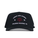 The No Rivals Texas A&M Outlaw Hat in black is a structured snapback with "TEXAS A&M AGGIES 1876 COLLEGE STATION, TX" and a maroon ATM logo embroidered on the front.