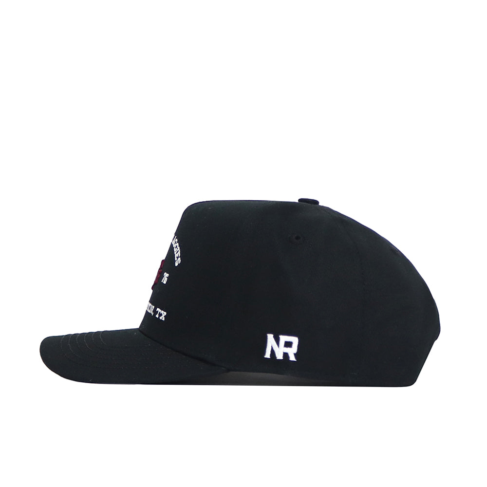 The Texas A&M Outlaw Hat - Black by No Rivals is a structured black snapback with a flat bill, white NR embroidery above the brim, and ventilation eyelets. Made from high-quality cotton.