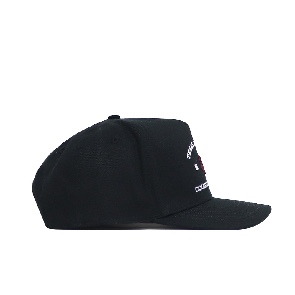 The No Rivals Texas A&M Outlaw Hat in black features white embroidered text and a red graphic on the front panel. Made of high-quality cotton, it has a flat brim, structured fit, and no visible side branding.