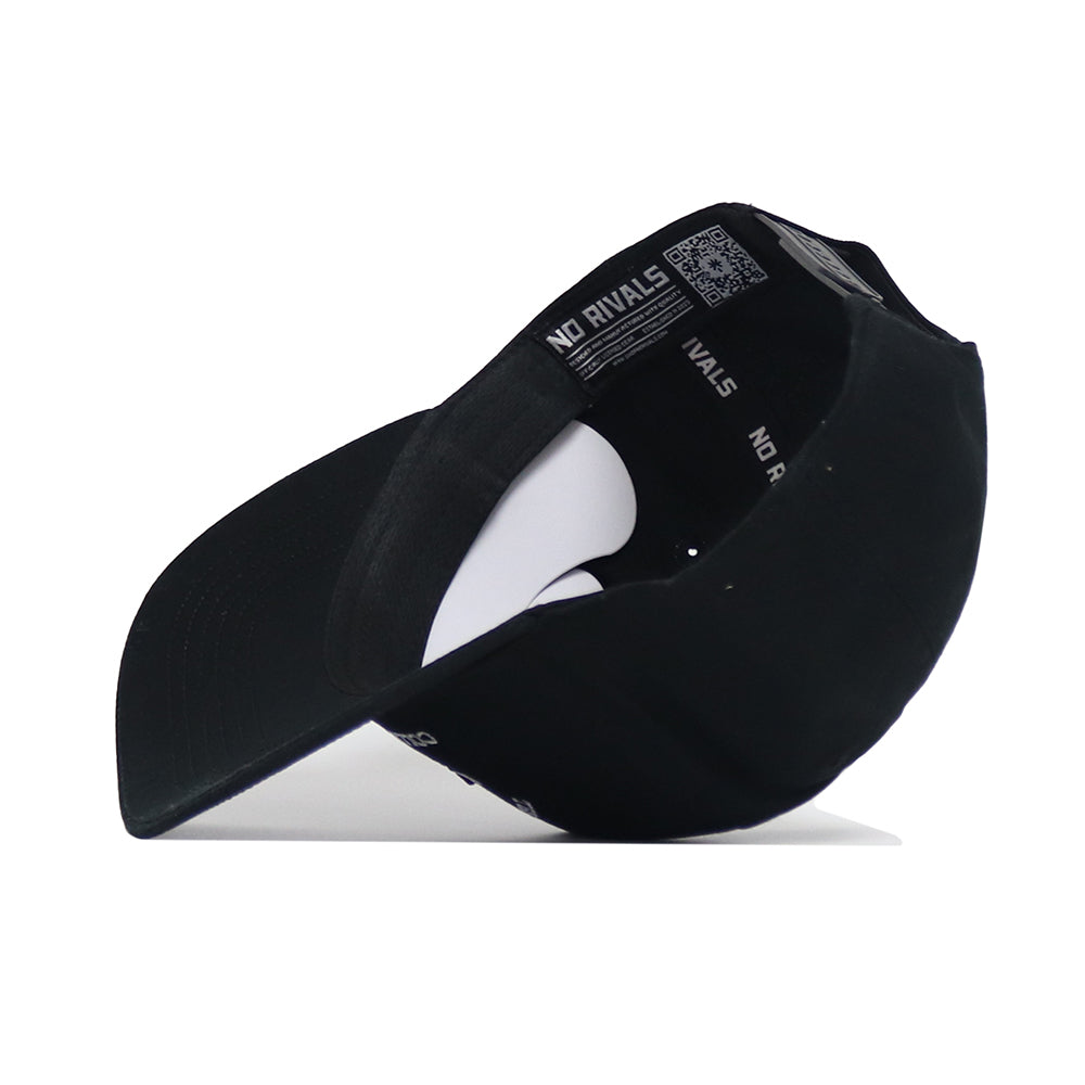 The Texas A&M Outlaw Hat - Black by No Rivals is flipped upside down to reveal its structured fit interior, inner band printed with "NO RIVALS," and a white sticker inside the crown highlighting high-quality cotton.