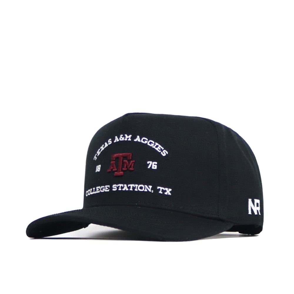 The Texas A&M Outlaw Hat - Black by No Rivals is a structured cotton baseball cap with "Texas A&M Aggies 1876 College Station, TX" and a maroon ATM logo embroidered on the front, plus white NR letters stitched on the side.