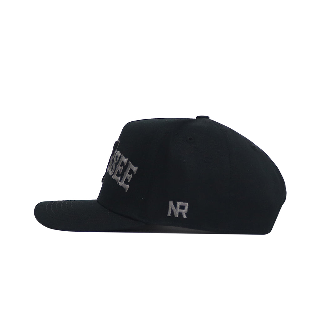 The No Rivals Tennessee Night Mode Hat is a black snapback shown in profile, with raised white "SEE" embroidery on the side and "NR" near the adjustable strap. It features a structured fit for lasting style.