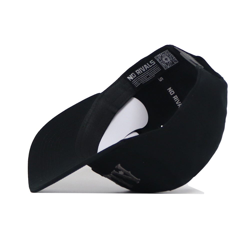 The Alabama Night Mode Hat by No Rivals is shown upside down, revealing its high-quality cotton interior with "NO RIVALS" on the inner band, a curved brim, and a visible QR code on the inner label.