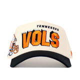 The No Rivals Tennessee Alma Mater Hat - Whiteout is a structured white cotton cap with TENNESSEE in black and bold orange VOLS on the front, plus a football helmet graphic on the left front panel.