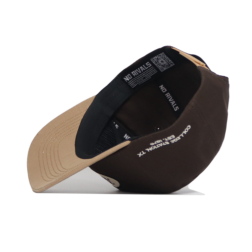 The Texas A&M Neutral Patch Hat by No Rivals features a brown and tan snapback design, structured fit, black mesh back, tan brim left, and inner label reading “COLLIER STATION TX” with a QR code on the band.