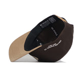 The Texas A&M Neutral Patch Hat by No Rivals features a brown and tan snapback design, structured fit, black mesh back, tan brim left, and inner label reading “COLLIER STATION TX” with a QR code on the band.