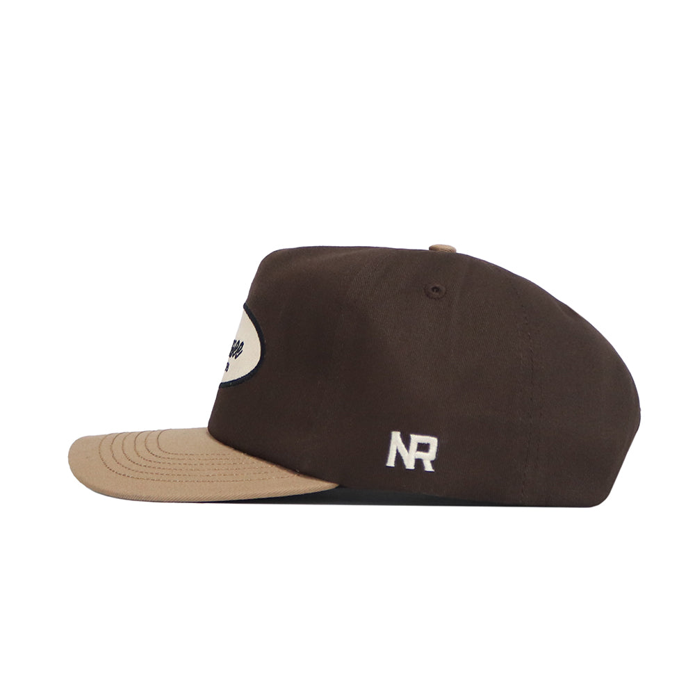 The Tennessee Neutral Patch Hat by No Rivals is a brown corduroy snapback with a beige brim, white embroidered NR on the side, a small beige button on top, and classic styling. Side view shown.