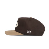 The Tennessee Neutral Patch Hat by No Rivals is a brown corduroy snapback with a beige brim, white embroidered NR on the side, a small beige button on top, and classic styling. Side view shown.
