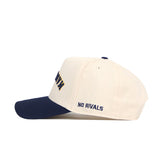 The Upside Down MARQUETTE Hat by No Rivals is a structured-fit, white cotton-canvas baseball cap with a navy brim and “NO RIVALS” embroidered in navy on the side.