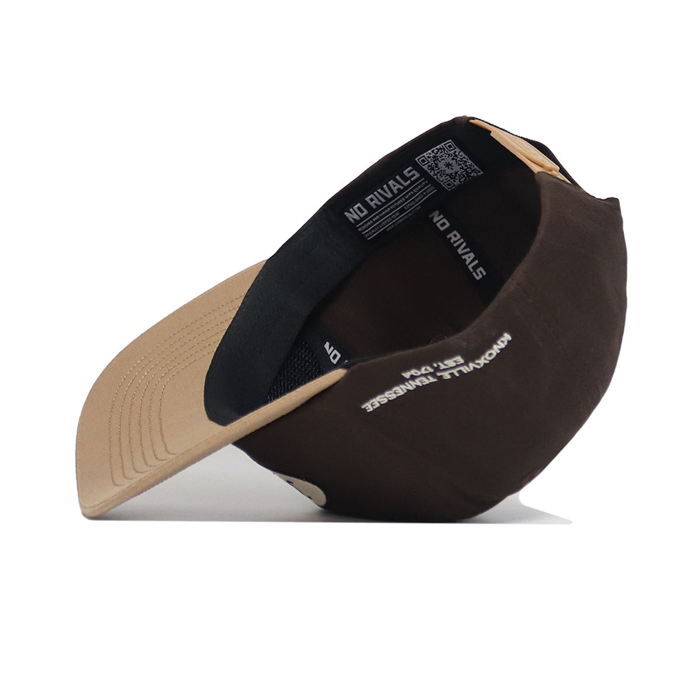 The Tennessee Neutral Patch Hat by No Rivals is shown on its side, revealing the inside black sweatband with "NO RIVALS" text and a QR code. The brown and beige corduroy cap features a curved brim, visible stitching, and classic baseball styling.