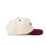 Introducing the Minnesota Gophers Vintage Hat by No Rivals—a cream-colored baseball cap featuring maroon stitching, a maroon button on top, and a matching maroon brim. Designed with a classic snap back closure for an ideal gameday fit, this cap is detailed with partial text on the side and an embroidered logo for extra style.