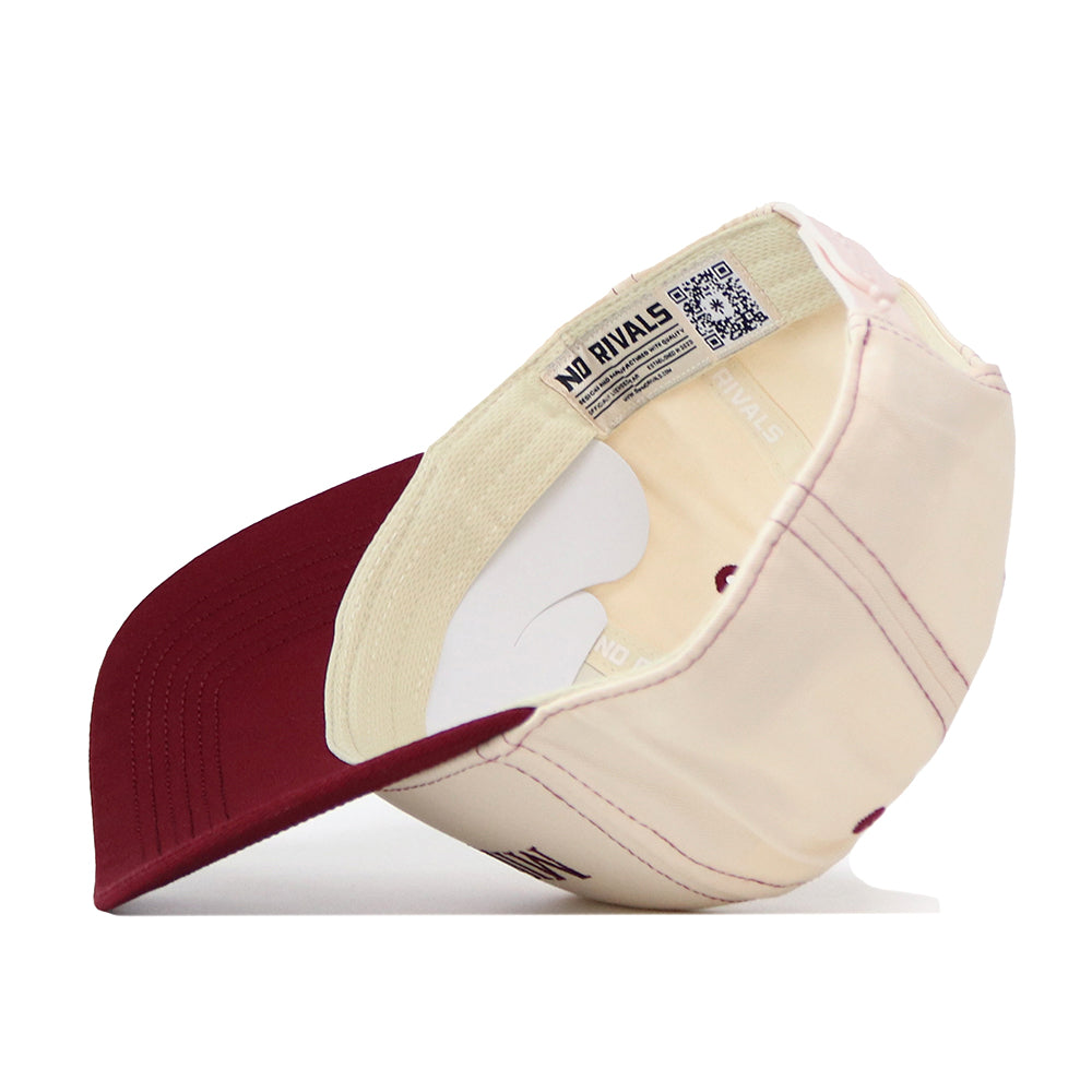 The Minnesota Gophers Vintage Hat by No Rivals is shown upside down to highlight the inside, where a label with text and a QR code is sewn onto the inner band. Featuring a classic snapback design for adjustable comfort, this cream and maroon baseball cap is an ideal choice for your gameday fit.