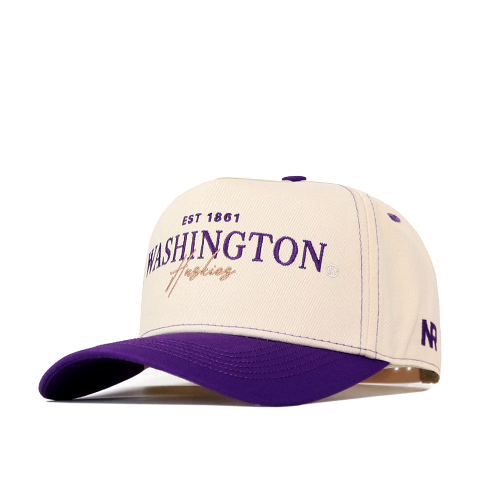 The Washington Huskies Vintage Hat by No Rivals is a cream and purple baseball cap crafted from high quality cotton, featuring “EST 1861 WASHINGTON Huskies” embroidered on the front, an NR logo on the side, and a snap back adjustment for a perfect fit.