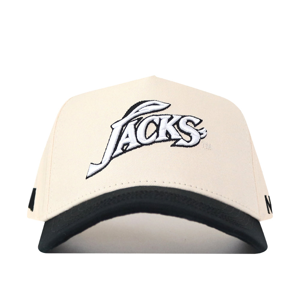 The South Dakota State Espresso Hat by No Rivals is a cream and black baseball cap viewed from the front, featuring “Jacks” embroidered in white and black stylized text on the front panel. The snapback closure ensures a perfect gameday fit, while the bold embroidered logo makes a standout statement.