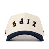 Introducing the Akron Zips | Upside Down Zips Hat - Classic by No Rivals: a white snapback baseball cap with a dark blue brim, showcasing “ZIPS” in large, navy-outlined letters sewn upside down on the front—a bold statement piece for any Akron Zips hat collector.