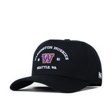 The Washington Huskies Outlaw Hat - Black by No Rivals is an officially licensed black baseball cap featuring a purple and gold embroidered W logo, with "Washington Huskies 1861 Seattle, WA" stitched above and below the logo. A small white '47 logo accents the side, and the snap back adjustment ensures a comfortable fit.