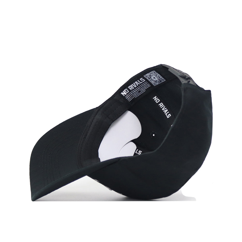 A black West Virginia Outlaw Hat by No Rivals is flipped upside down, revealing the white NO RIVALS text on the inside and a curved brim. An embroidered logo adds style, while the interior tag and a small white insert are also visible.