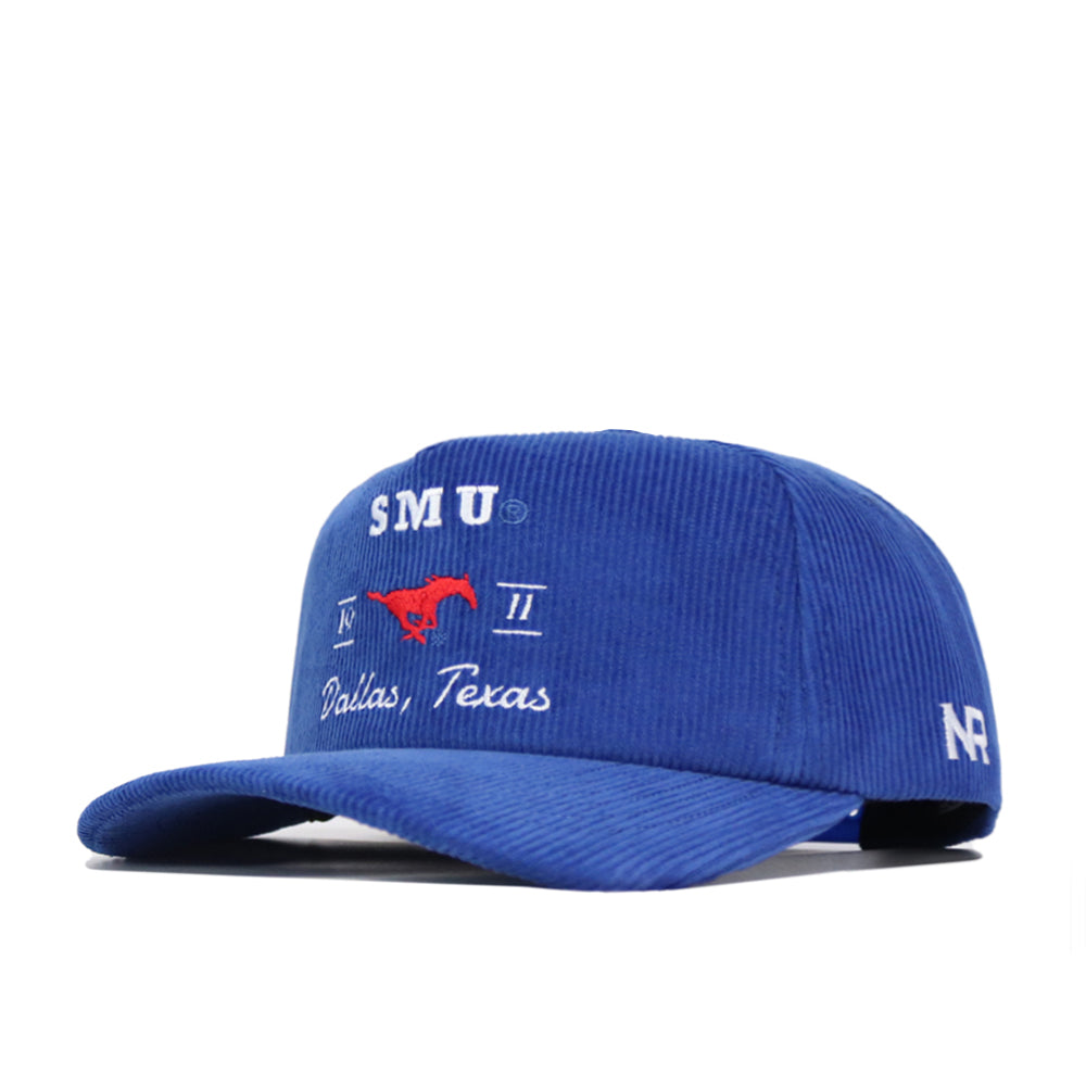 The SMU Vintage Cord Hat is a blue corduroy cap with "SMU," a red mustang logo, and "Dallas, Texas" embroidered on the front. White "NF" initials are stitched on the left side. An adjustable snap back closure ensures a custom fit.